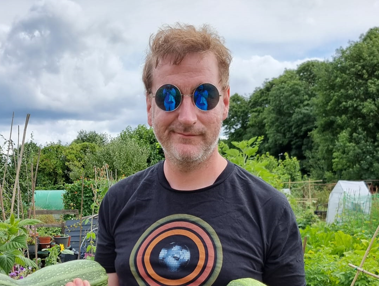 James in a pair of sunglasses, wearing an Arctic Monkeys t-shirt, wondering if he'll ever look as cool as this when he's not holding a pair of marrows.